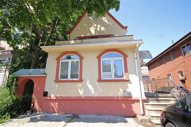 a front view of a house with garden