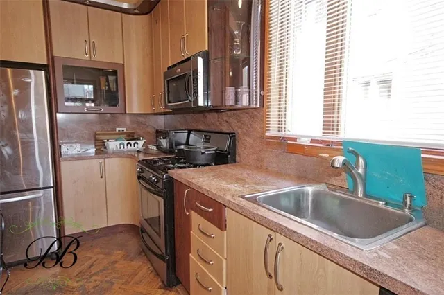 a kitchen that has a sink and a stove