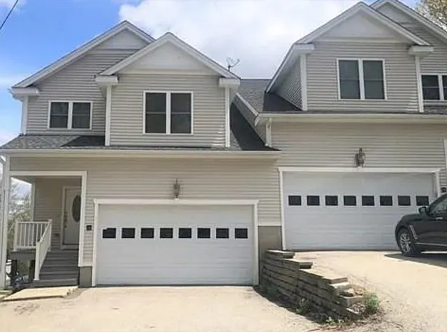 a view of a white house with large windows