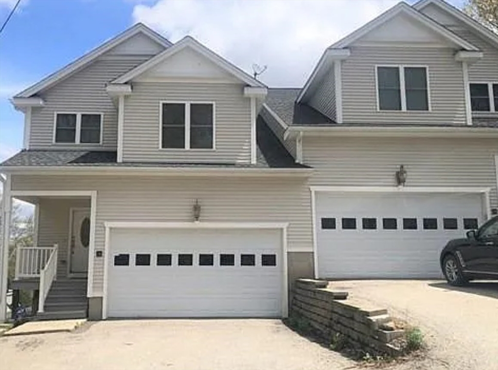 a view of a white house with large windows