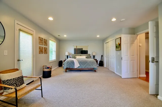 a view of a hallway with closet and a bathroom