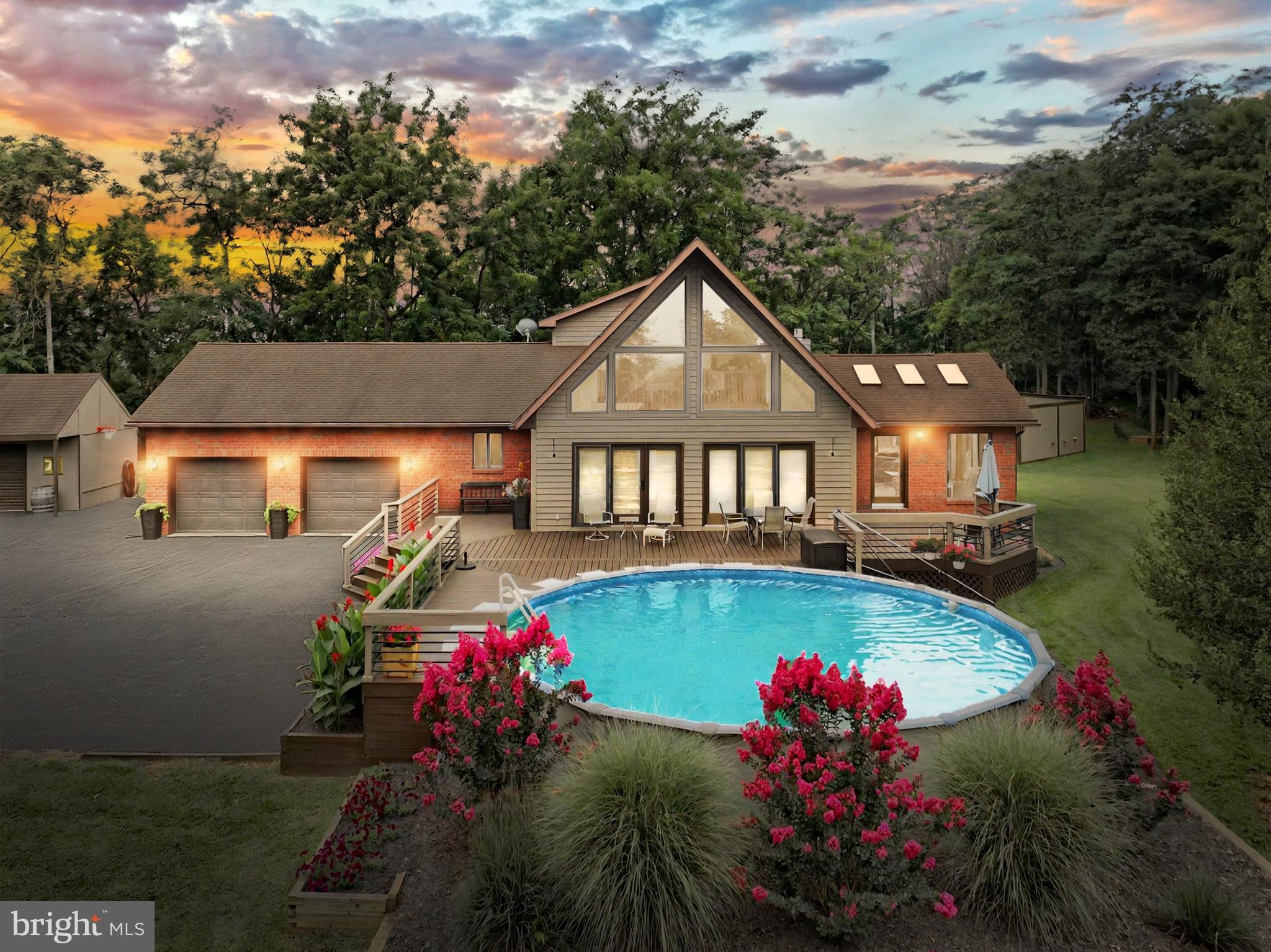 a view of a house with swimming pool and a yard