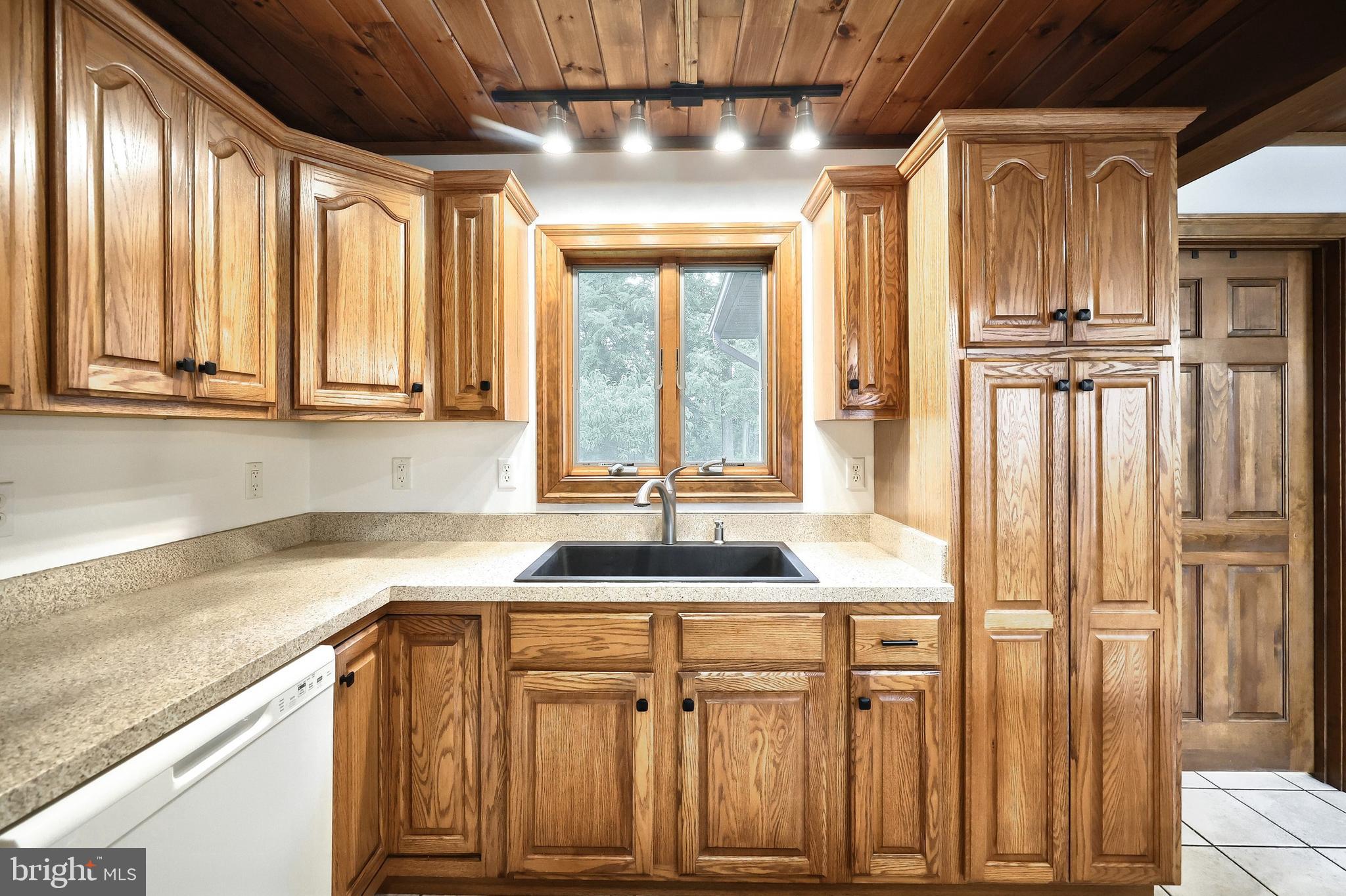 312 Knox Road Gettysburg, PA 17325 - Photo 28 of 50 a kitchen with granite countertop a sink and a refrigerator