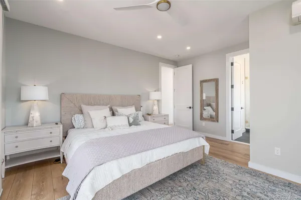 a spacious bedroom with a bed and a lamp