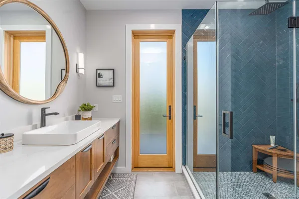 a bathroom with a double vanity sink and a mirror