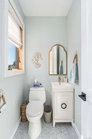 a bathroom with a toilet sink and mirror