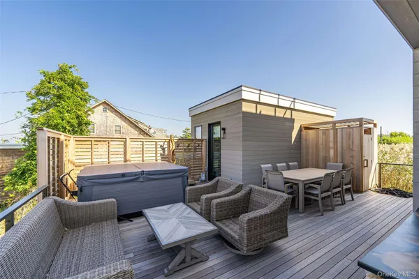 a balcony with furniture and a potted plant