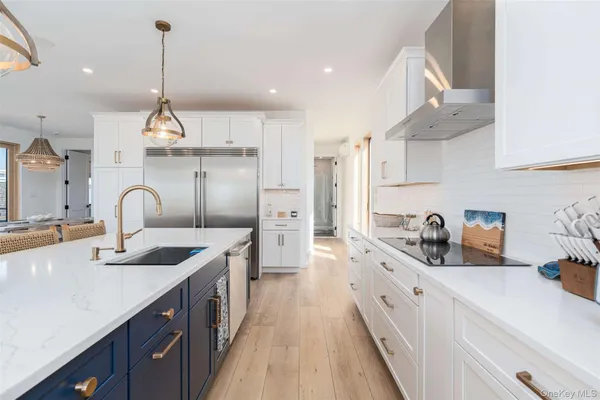 a kitchen with granite countertop a sink a counter space appliances and cabinets