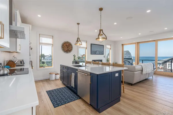 a kitchen with a sink stove and wooden floor