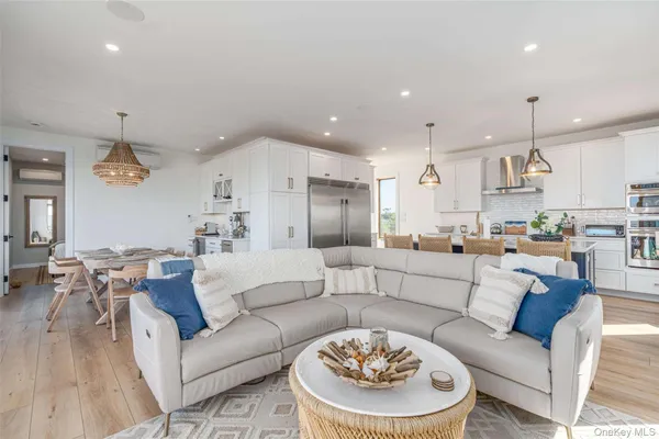a living room with furniture kitchen and a table