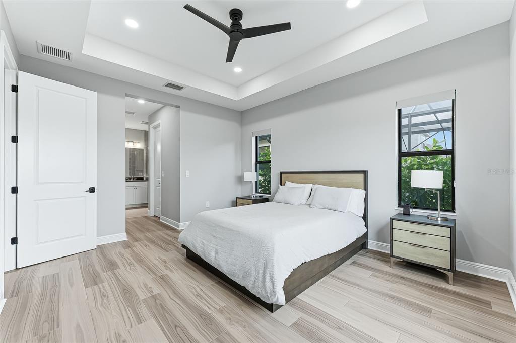4191 Pegasus Way Naples, FL 34120 - Photo 19 of 48 a large bedroom with a bed and a chandelier