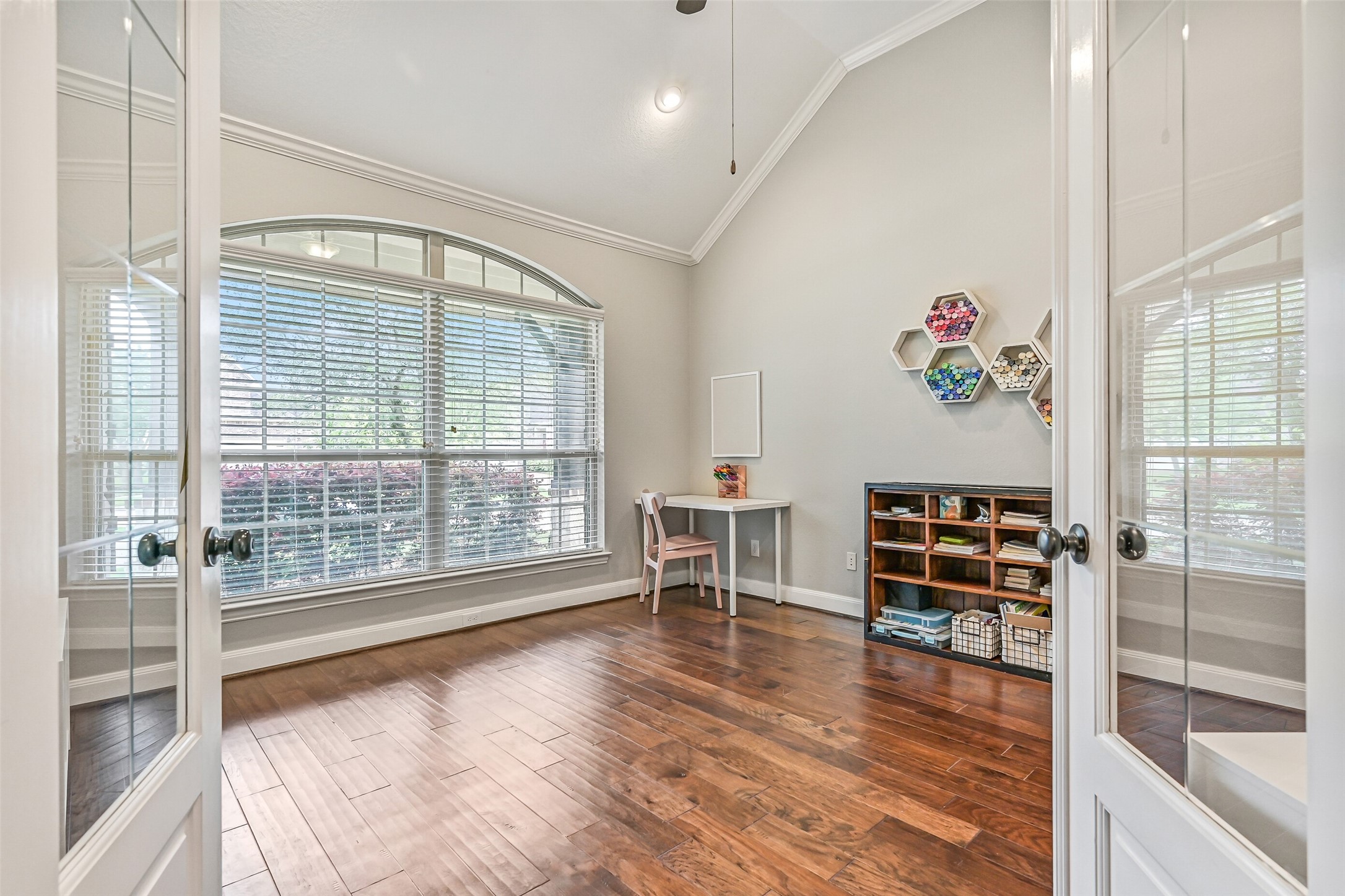 1008 Point Isabel Lane Friendswood, TX 77546 - Photo 8 of 50 Just off the entry, a private study offers engineered wood floors, French doors, high ceilings trimmed withcrown molding, and a large palladium window that fills the space with natural light, ideal for a home office or quiet retreat.