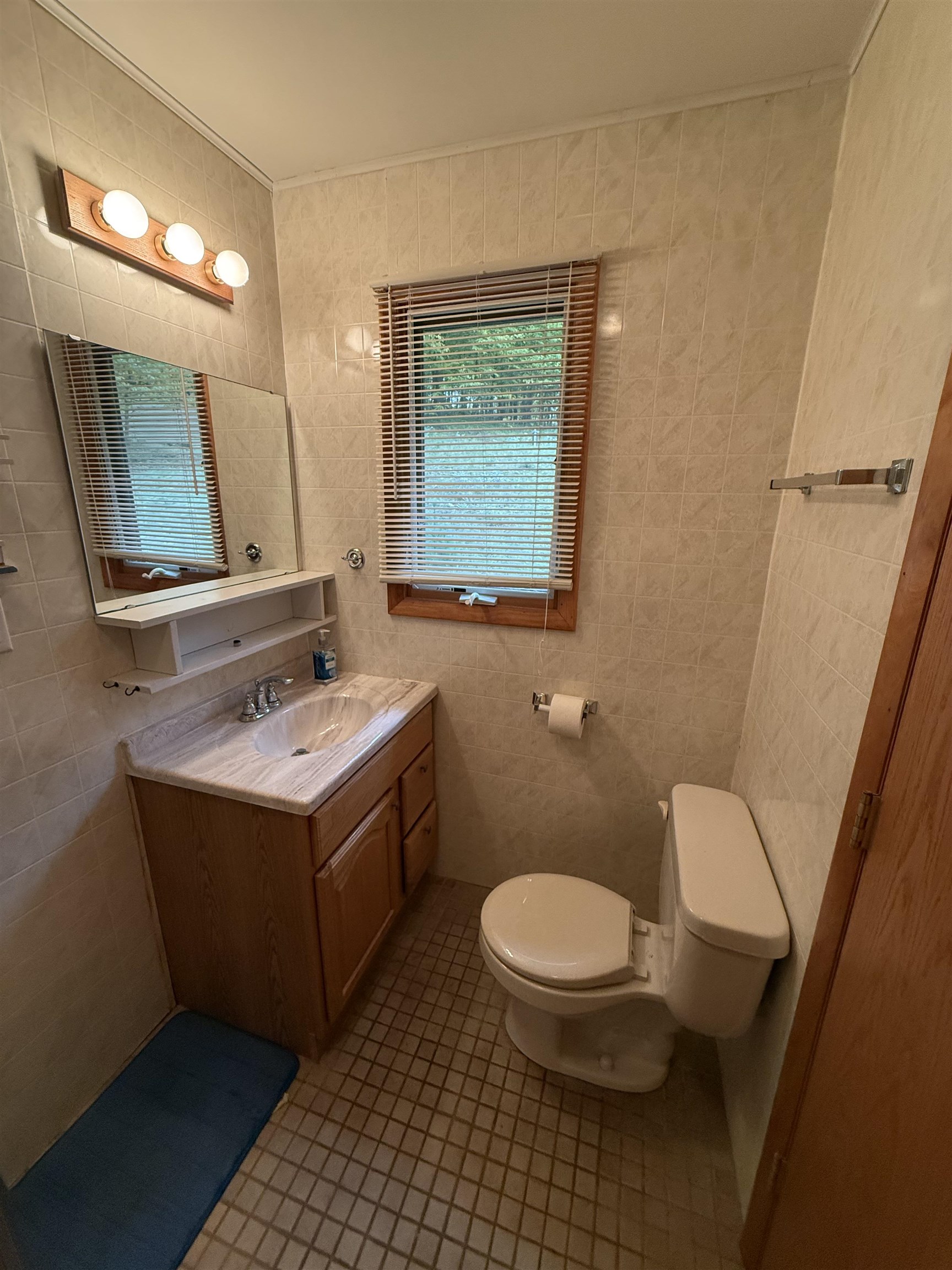 63380 Trout Lake Road Iron River, WI 54847 - Photo 19 of 36 Half bath with tile walls, tile patterned floors, and vanity