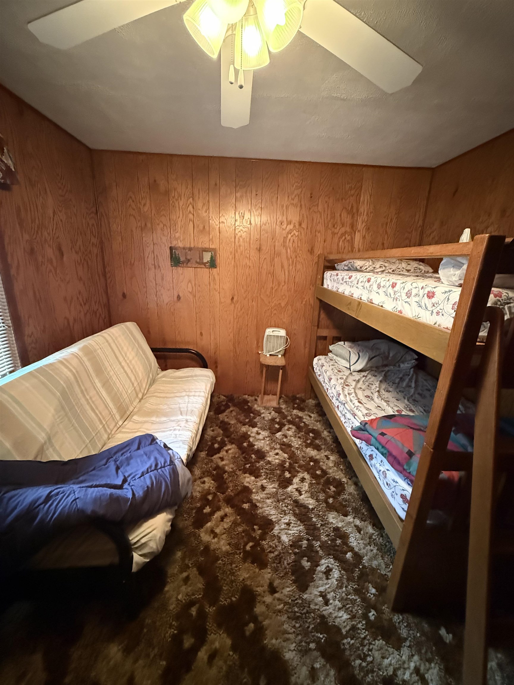 63380 Trout Lake Road Iron River, WI 54847 - Photo 21 of 36 Bedroom with wood walls and a ceiling fan