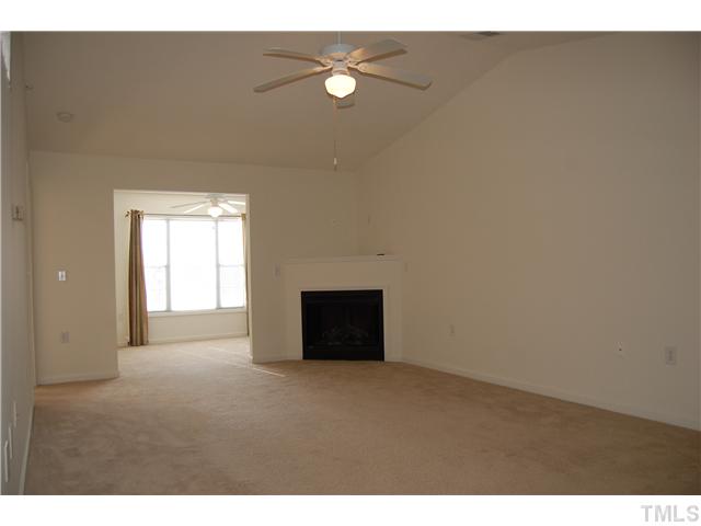 2510 Huntscroft Lane, Unit 203 Raleigh, NC 27617 - Photo 3 of 12 a view of an empty room with wooden floor and a window