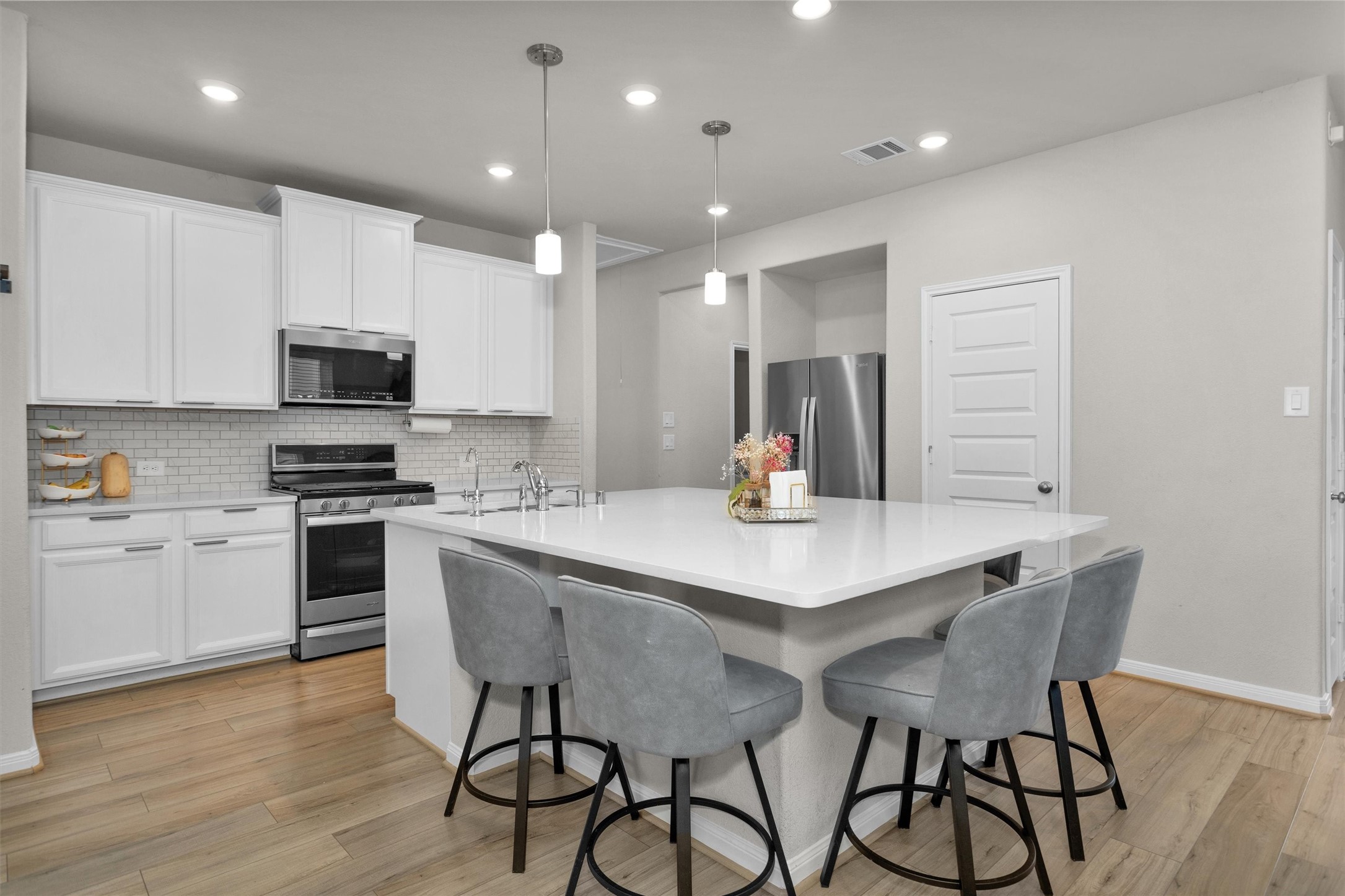 18544 Meadow Point Lane Montgomery, TX 77316 - Photo 11 of 35 a kitchen with a table chairs microwave and cabinets