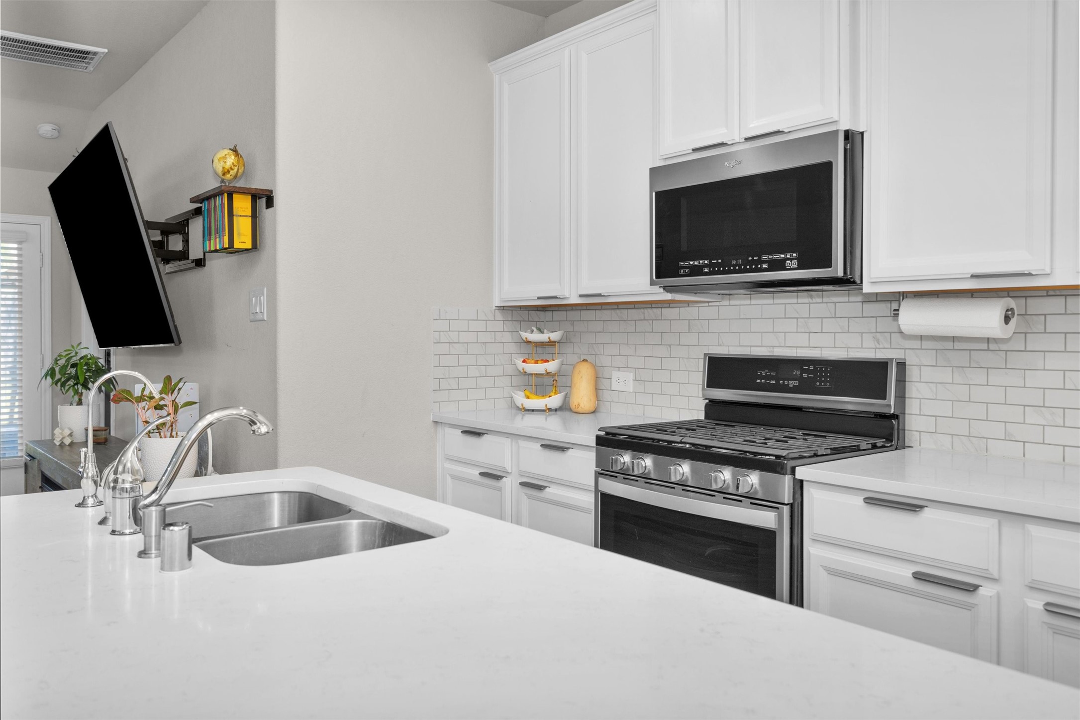 18544 Meadow Point Lane Montgomery, TX 77316 - Photo 13 of 35 a kitchen with stainless steel appliances a stove a microwave a sink and cabinets