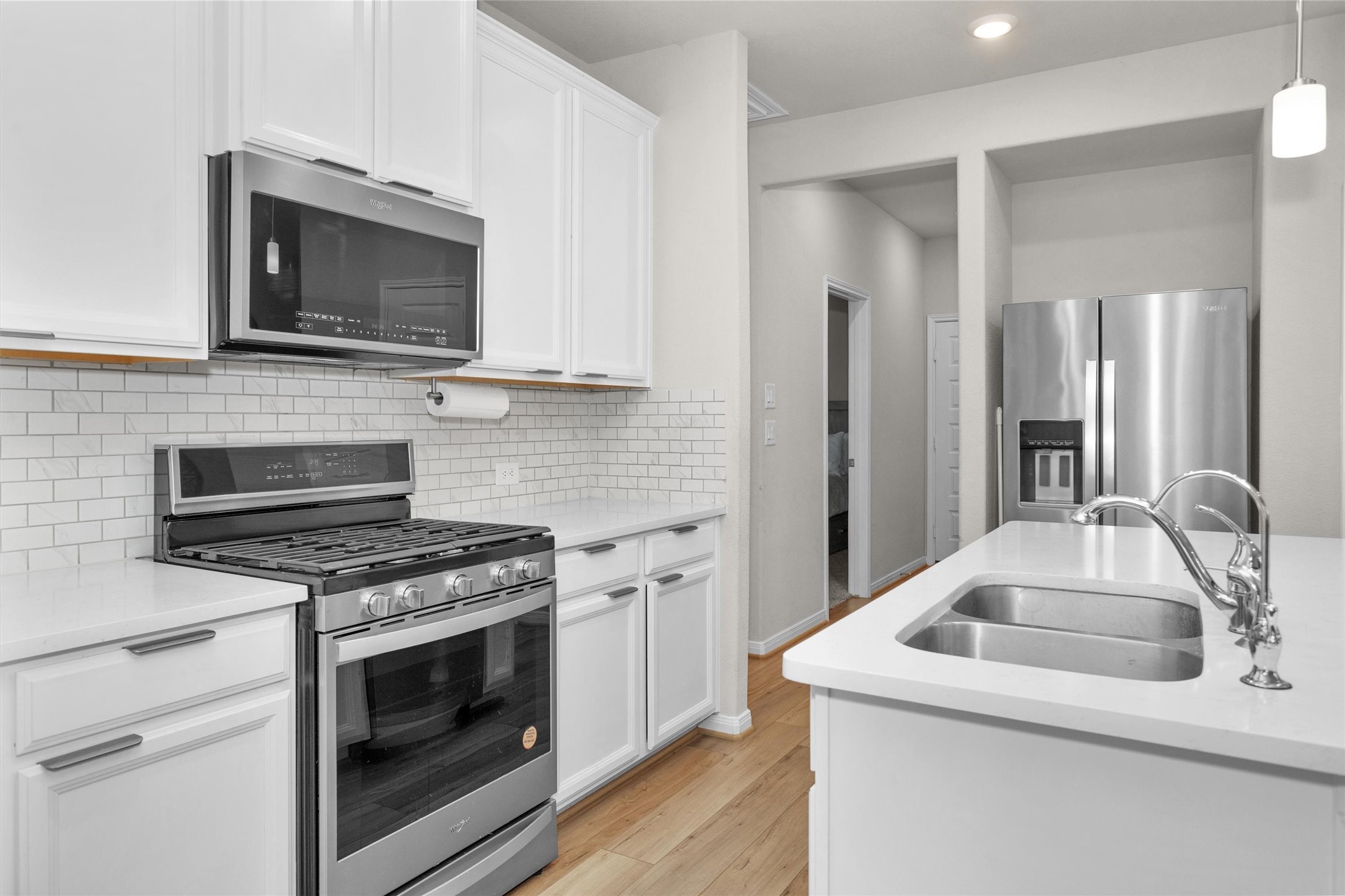 18544 Meadow Point Lane Montgomery, TX 77316 - Photo 14 of 35 a kitchen with sink stove and microwave
