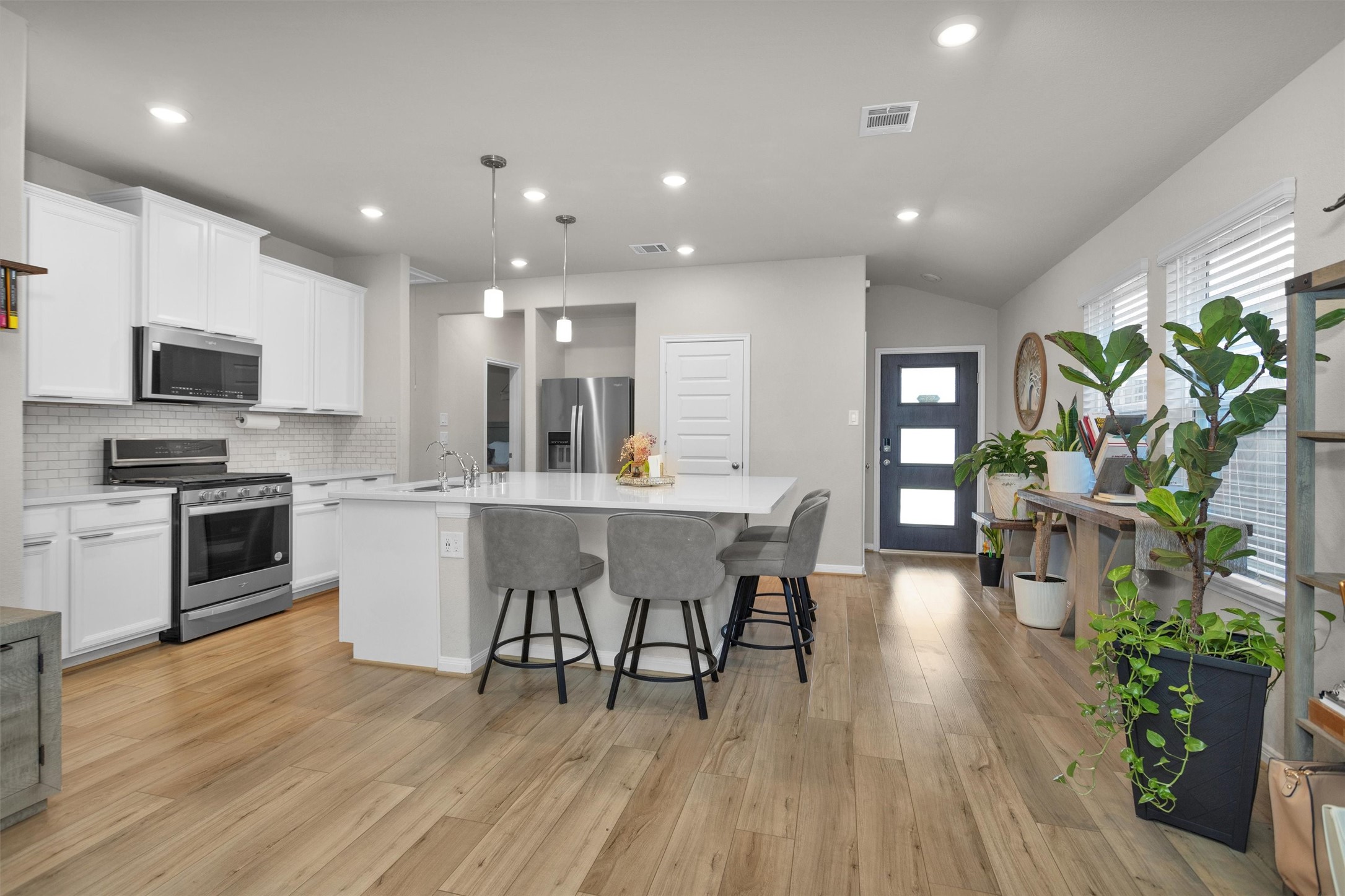 18544 Meadow Point Lane Montgomery, TX 77316 - Photo 10 of 35 a kitchen with a table chairs refrigerator and microwave