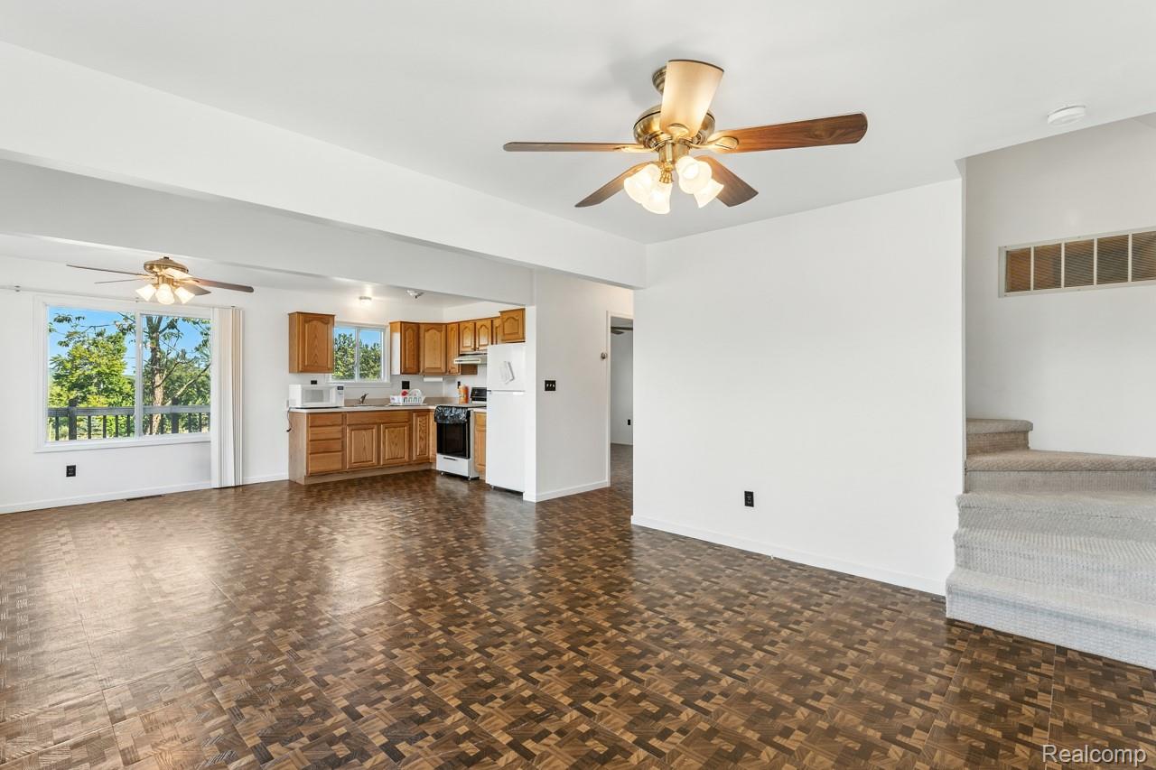 9720 East Kellyville Road Atlanta, MI 49709 - Photo 22 of 34 Unfurnished living room featuring a ceiling fan and baseboards
