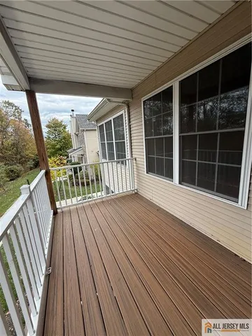 a bathroom with a toilet a sink a mirror and shower