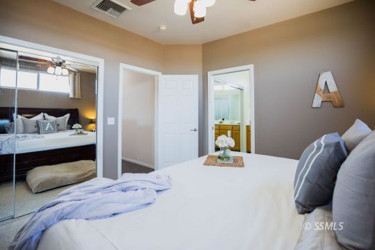 812 South Nevada Street Ridgecrest, CA 93555 - Photo 24 of 34 a bedroom with a bed and a mirror