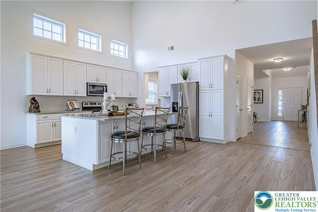 a kitchen with stainless steel appliances a refrigerator and a stove top oven