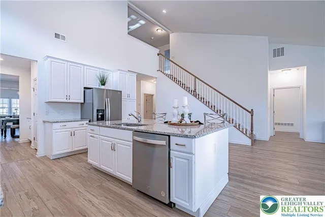 a kitchen with appliances a sink and cabinets