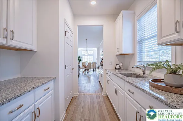 a kitchen with granite countertop lots of counter space and wooden floor