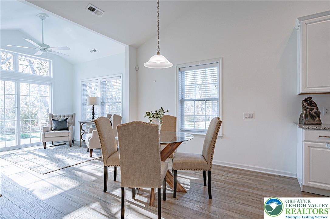 3855 Victors Way Easton, PA 18045 - Photo 19 of 47 a dining room with furniture a chandelier and wooden floor