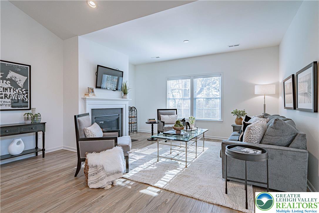 3855 Victors Way Easton, PA 18045 - Photo 21 of 47 a living room with furniture and a fireplace