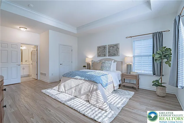 a bedroom with a bed table and a couch