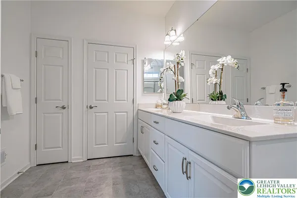 a bathroom with a double vanity sink and a mirror