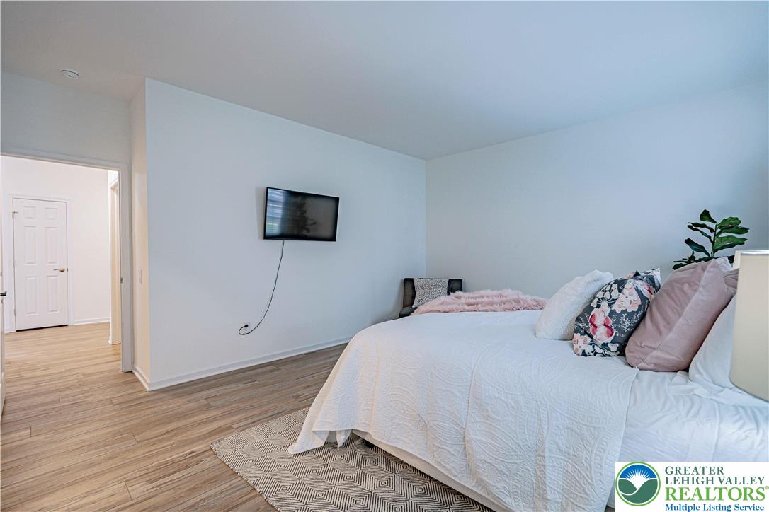 3855 Victors Way Easton, PA 18045 - Photo 34 of 47 a bedroom with a bed and a wooden floor