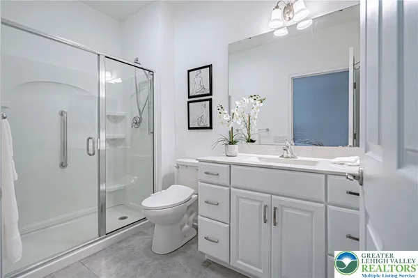 a bathroom with a toilet sink and shower