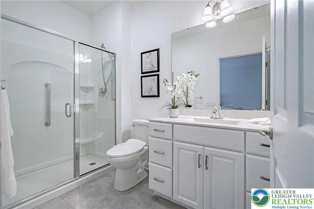 a bathroom with a toilet sink and shower