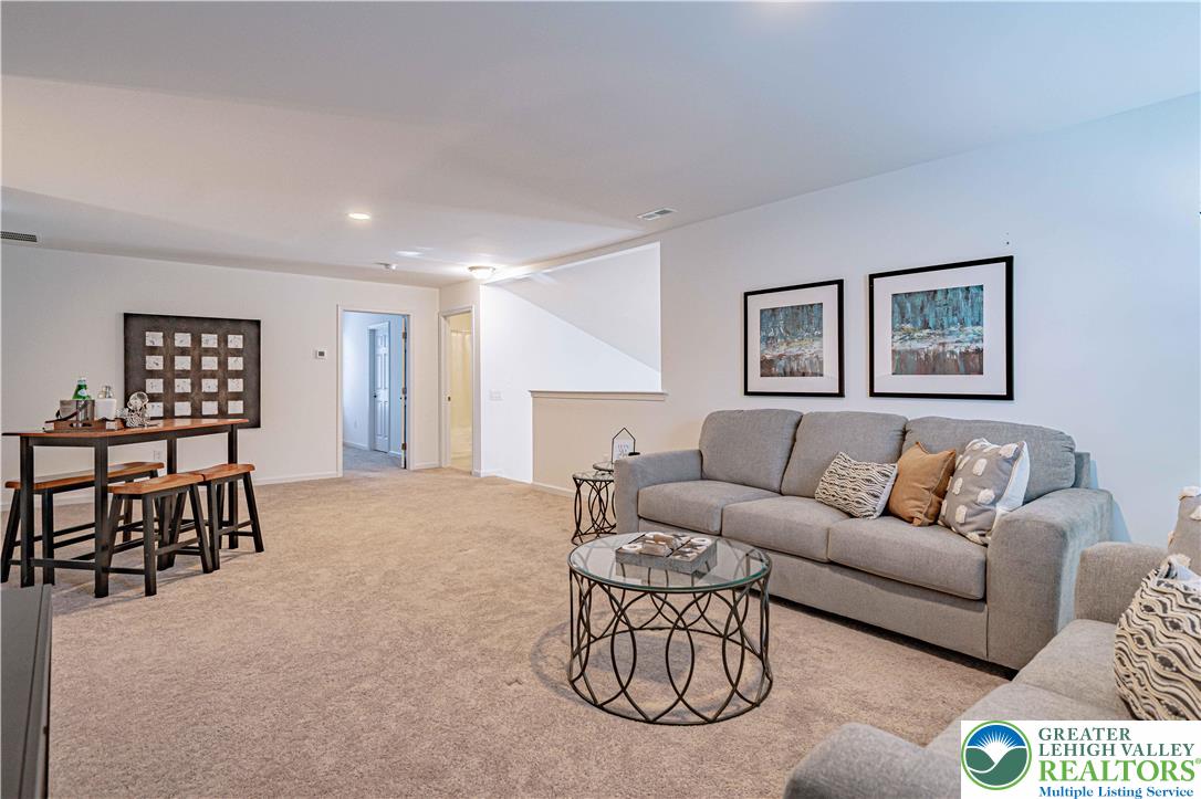 3855 Victors Way Easton, PA 18045 - Photo 38 of 47 a living room with furniture a rug and a window