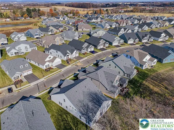 an aerial view of a residential houses with outdoor space