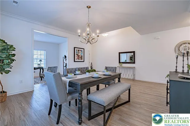 a view of a dining room with furniture wooden floor and a chandelier