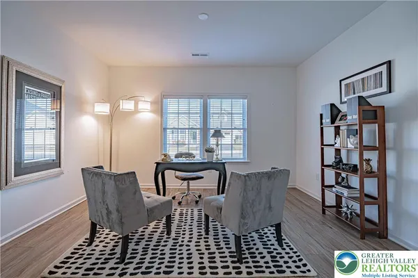 a view of a workspace with furniture and a window