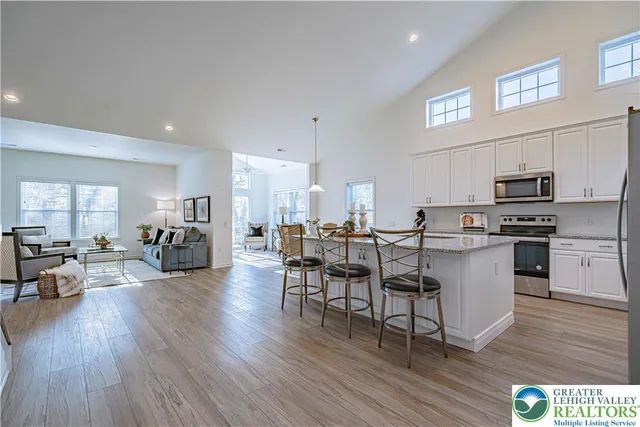 a kitchen with a table chairs refrigerator and cabinets