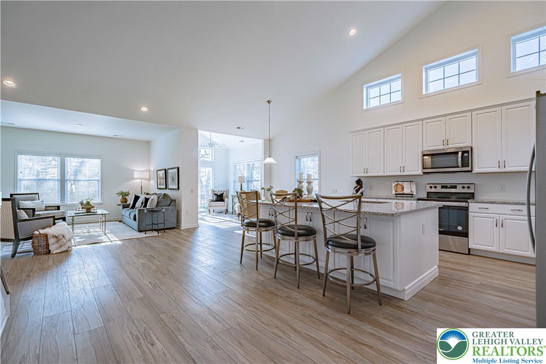 3855 Victors Way Easton, PA 18045 - Photo 9 of 47 a kitchen with a table chairs refrigerator and cabinets