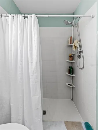 a bathroom with a shower curtain and a shower curtain