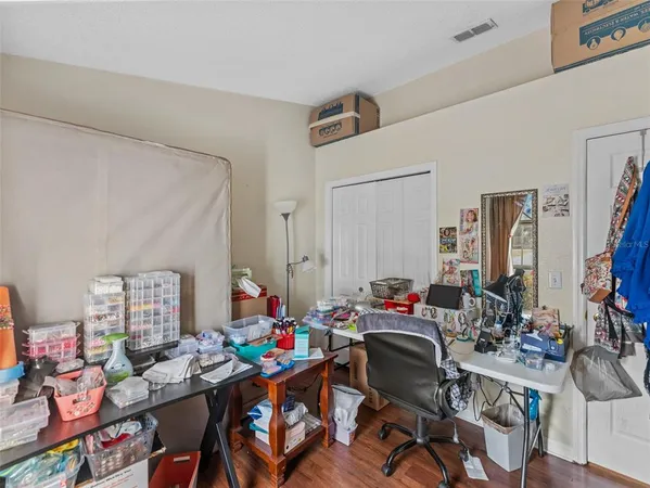 a work room with furniture and wooden floor