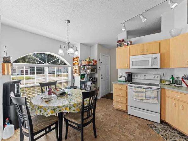 a dinning table and chairs in a kitchen