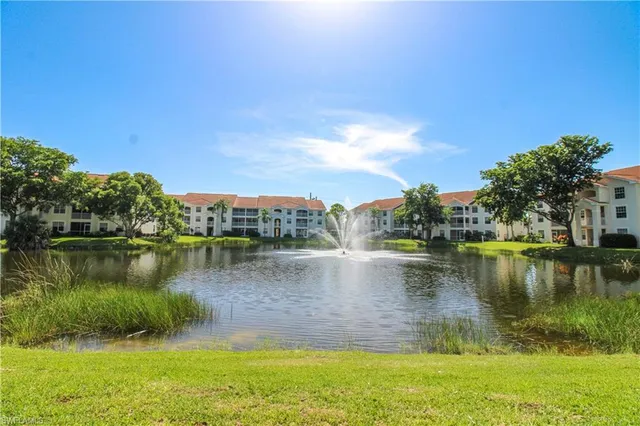 a view of a lake with houses in background