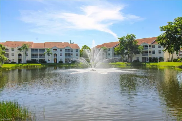 a view of a lake with houses in the back