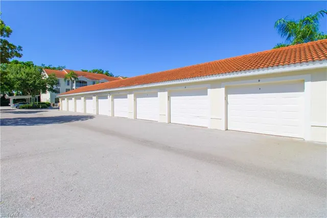 a row of cars parked in front of a house