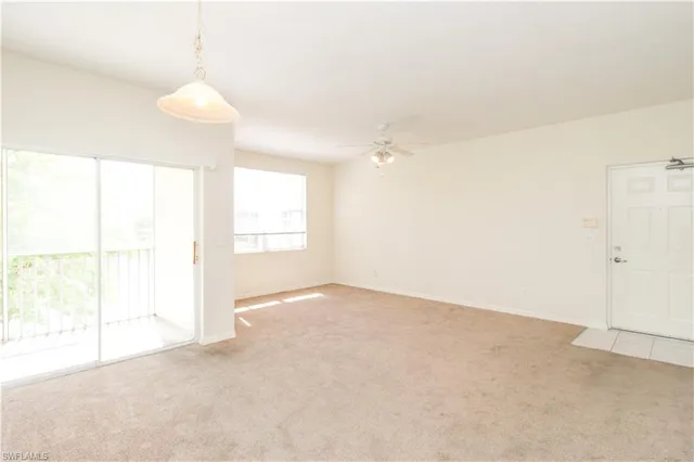 a view of a kitchen with white cabinets