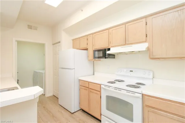 a kitchen with a sink and a refrigerator
